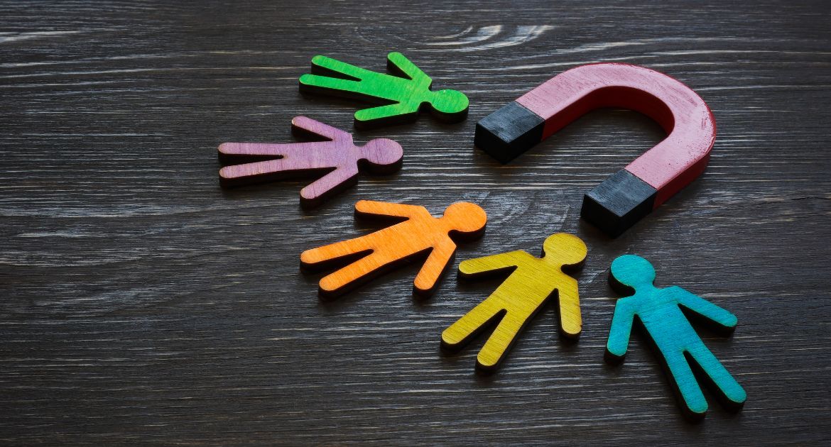 A wooden magnet pulling in wooden figures
