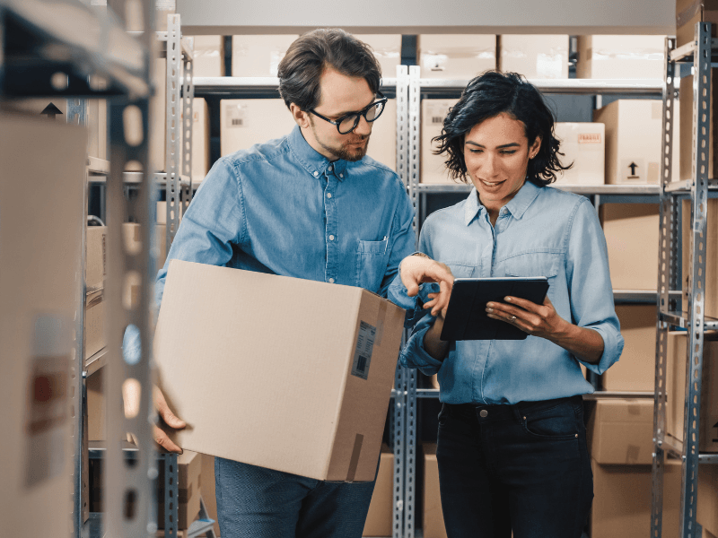 Two people in a warehouse